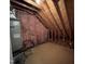 Unfinished attic space with exposed wood beams, insulation and mechanical equipment at 3110 Fieldstone Ln, Mebane, NC 27302