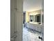 Bright bathroom featuring double vanity, decorative tile flooring, and neutral paint at 3110 Fieldstone Ln, Mebane, NC 27302