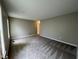 Spacious bedroom featuring neutral carpet, ample natural light, and a view of the backyard at 3110 Fieldstone Ln, Mebane, NC 27302