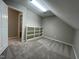 A carpeted room with a built-in bookcase and an open door at 3110 Fieldstone Ln, Mebane, NC 27302
