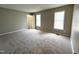 Bright, carpeted bedroom features two windows for natural light and a door to another room at 3110 Fieldstone Ln, Mebane, NC 27302
