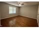 Bright bedroom with hardwood floors, a ceiling fan, and a large window at 3110 Fieldstone Ln, Mebane, NC 27302