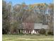 Charming brick home with lovely landscaping and a blooming tree in the front yard at 3110 Fieldstone Ln, Mebane, NC 27302
