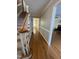 Hallway showcasing hardwood floors, decorative trim, and access to other rooms at 3110 Fieldstone Ln, Mebane, NC 27302