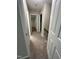 Upstairs hallway featuring carpet floors and doors to other bedrooms at 3110 Fieldstone Ln, Mebane, NC 27302