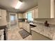 Cozy kitchen featuring granite countertops, white cabinets, a stainless steel sink, and modern appliances at 3110 Fieldstone Ln, Mebane, NC 27302
