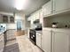 Modern kitchen with granite countertops, white cabinets, stainless steel appliances, and tile floors at 3110 Fieldstone Ln, Mebane, NC 27302