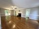 Spacious living room featuring hardwood floors, a fireplace, and access to the outdoor deck at 3110 Fieldstone Ln, Mebane, NC 27302