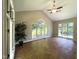 Bright sunroom with brick floors, lots of natural light from the numerous windows and a ceiling fan at 3110 Fieldstone Ln, Mebane, NC 27302