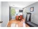 Serene bedroom with hardwood floors, desk, treadmill, and two windows offering natural light at 318 Fieldstone Dr, Burlington, NC 27215