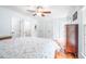 Spacious bedroom featuring hardwood floors, a ceiling fan, and three closets at 318 Fieldstone Dr, Burlington, NC 27215