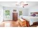 Comfortable bedroom with hardwood floors and large windows providing ample natural light at 318 Fieldstone Dr, Burlington, NC 27215