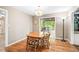 Cozy dining room with hardwood floors and a view into the naturally lit living room at 318 Fieldstone Dr, Burlington, NC 27215