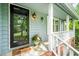 Inviting front porch with a decorative pineapple theme and a quaint outdoor light fixture at 318 Fieldstone Dr, Burlington, NC 27215