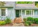 Charming front porch with brick steps, decorative plants, and an inviting entrance at 318 Fieldstone Dr, Burlington, NC 27215
