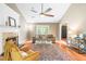 Cozy living room featuring a fireplace, large windows, and comfortable seating arrangements at 318 Fieldstone Dr, Burlington, NC 27215