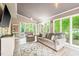 Bright sun room with ample seating and natural light streaming through large windows at 318 Fieldstone Dr, Burlington, NC 27215