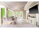 Bright and airy sun room with multiple windows, a vaulted ceiling, and stylish decor at 318 Fieldstone Dr, Burlington, NC 27215