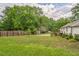 Expansive backyard with green space, a storage shed, and perimeter fencing at 3620 Constellation Dr, Raleigh, NC 27604