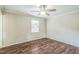 Cozy bedroom with hardwood floors, neutral walls, and a ceiling fan at 3620 Constellation Dr, Raleigh, NC 27604