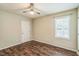 Bedroom with hardwood flooring, neutral walls, ceiling fan, and window at 3620 Constellation Dr, Raleigh, NC 27604