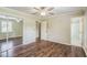 Bedroom featuring hardwood floors, closet with mirrored doors, ceiling fan and an attached bath at 3620 Constellation Dr, Raleigh, NC 27604