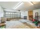 Spacious garage with roll-up door, concrete floors, and ample storage and workspace at 3620 Constellation Dr, Raleigh, NC 27604