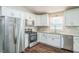 Modern kitchen features stainless steel appliances, white cabinets and granite countertops at 3620 Constellation Dr, Raleigh, NC 27604