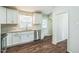 Clean kitchen featuring stainless steel appliances, white cabinets, and hardwood floors at 3620 Constellation Dr, Raleigh, NC 27604