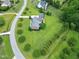 Residential property with long driveway, mature trees, detached garage, and sprawling lawn in a quiet neighborhood at 4005 Olde Waverly Way, Fuquay Varina, NC 27526