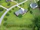 Overhead view of lushly landscaped lawn with mature trees, featuring a beautiful brick home with a detached garage at 4005 Olde Waverly Way, Fuquay Varina, NC 27526