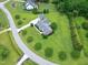 Desirable neighborhood lot with circular street, lush lawn, manicured shrubs, and brick home featuring detached garage at 4005 Olde Waverly Way, Fuquay Varina, NC 27526