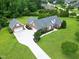 Gorgeous brick home features manicured front yard, detached garage, and long driveway, nestled in lush landscaping at 4005 Olde Waverly Way, Fuquay Varina, NC 27526
