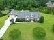 Aerial view featuring the home with its large lot, mature trees, and pristine curb appeal at 4005 Olde Waverly Way, Fuquay Varina, NC 27526