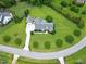 Expansive property with manicured lawn, mature trees, and a well-maintained home featuring a detached garage and extended driveway at 4005 Olde Waverly Way, Fuquay Varina, NC 27526