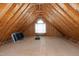 Expansive attic space with high ceilings, wood beams, and natural light from a window, perfect for storage at 4005 Olde Waverly Way, Fuquay Varina, NC 27526