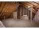 Unfinished attic area showcasing exposed rafters and plywood flooring, ideal for storage or expansion at 4005 Olde Waverly Way, Fuquay Varina, NC 27526