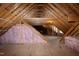 Spacious unfinished attic featuring exposed wooden beams and insulation, ready for customization at 4005 Olde Waverly Way, Fuquay Varina, NC 27526