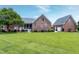 Well-maintained backyard featuring a brick home, screened porch, and manicured landscaping at 4005 Olde Waverly Way, Fuquay Varina, NC 27526