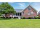 Brick home with a screened porch and manicured landscaping in the backyard at 4005 Olde Waverly Way, Fuquay Varina, NC 27526