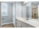 This bathroom features a big mirror, storage cabinet with a sink, and a shower at 4005 Olde Waverly Way, Fuquay Varina, NC 27526