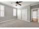 This bedroom features two closets and a window with modern white shutters for natural light at 4005 Olde Waverly Way, Fuquay Varina, NC 27526
