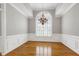 Elegant dining room featuring decorative molding, wood floors and large windows at 4005 Olde Waverly Way, Fuquay Varina, NC 27526