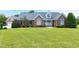 Charming brick home featuring a well manicured lawn and inviting front porch at 4005 Olde Waverly Way, Fuquay Varina, NC 27526