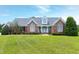 Charming brick home featuring a well manicured lawn and inviting front porch at 4005 Olde Waverly Way, Fuquay Varina, NC 27526