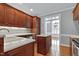 Cozy kitchen features wood cabinets, an island with sink and bright countertops at 4005 Olde Waverly Way, Fuquay Varina, NC 27526