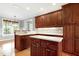 A lovely kitchen features an island, wooden cabinets and bright countertops at 4005 Olde Waverly Way, Fuquay Varina, NC 27526