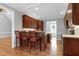 Spacious kitchen offers wood floors, a breakfast bar, wooden cabinets and modern lighting at 4005 Olde Waverly Way, Fuquay Varina, NC 27526