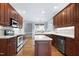 This kitchen is complete with wood cabinets, an island and stainless steel appliances at 4005 Olde Waverly Way, Fuquay Varina, NC 27526