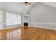 Spacious living room with vaulted ceilings, hardwood floors, and a cozy fireplace at 4005 Olde Waverly Way, Fuquay Varina, NC 27526